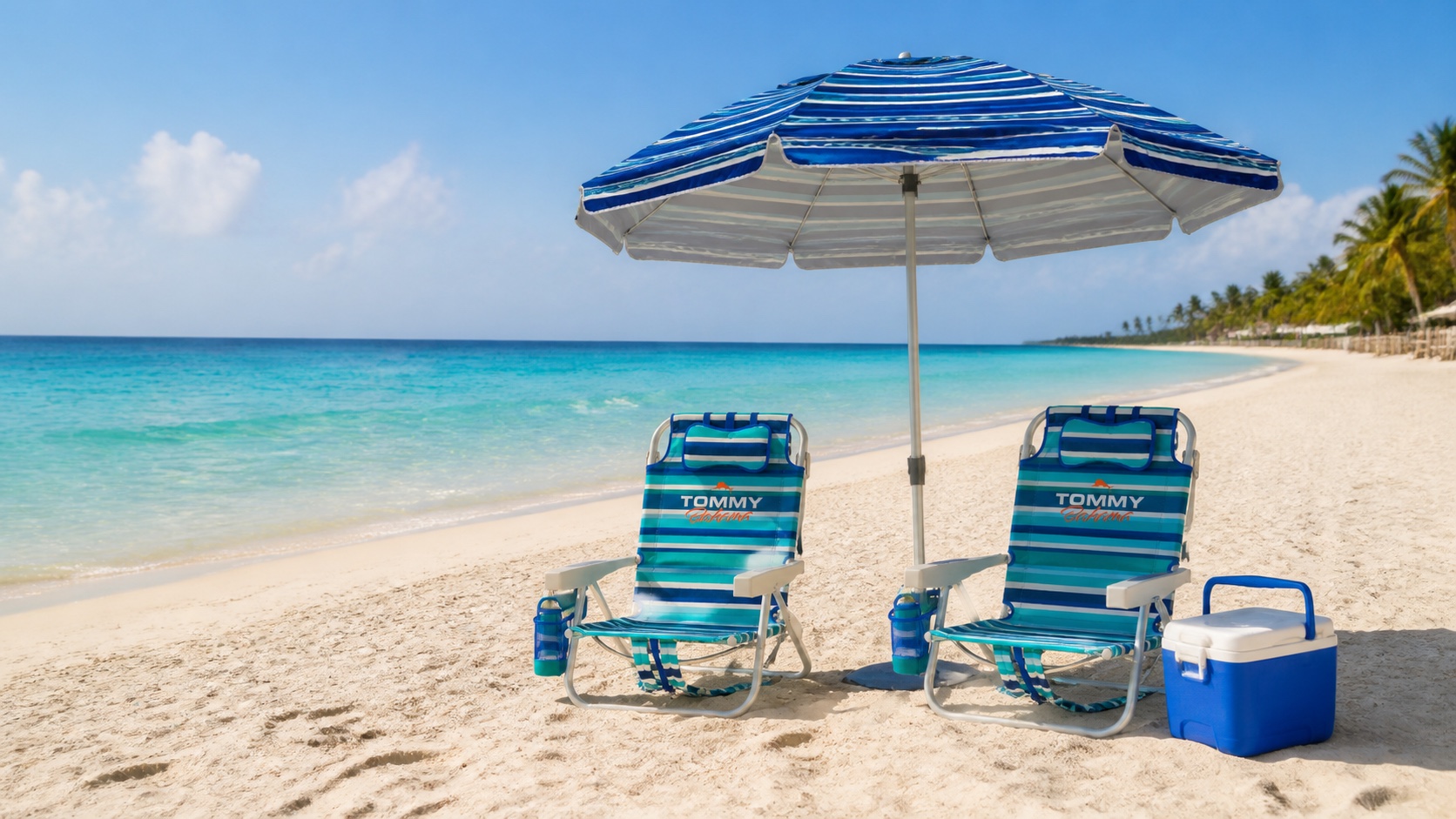 Reclining chairs, a blue beach umbrella, and cooler ready by the sea